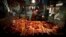 China -- A woman points for a customer, to cuts of pork for sale at her small stall located in a meat market in central Beijing