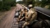 UKRAINE – Ukrainian artillerymen sits on a self-propelled 203mm cannon '2S7 Pion' on the southern frontline of Ukraine on September 14, 2022