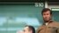 U.K. -- Chelsea's owner Roman Abramovich (R) looks on from his box during the Premiership football match against Portsmouth at Stamford Bridge in London, 21Oct2006