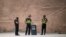 China-This picture taken on June 25, 2017 shows police guarding the streets near the old city in Kashgar in China's Xinjiang Uighur Autonomous Region, a day before the Eid al-Fitr holiday. - Xinjiang has seen an explosion in the construction of “vocationa