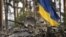 UKRAINE – Ukrainian servicemen ride on an armored transporter driving through a Russian position overran by Ukrainian forces outside Kyiv, March 31, 2022
