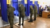Servicemen vote in the 2021 Russian parliamentary election at polling station No 202 at secondary school No 10 in the village of Peschanka