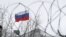 UKRAINE – The Russian flag, seen through barbed wire, flies over the Russian Embassy in Kyiv, 27 December 2018