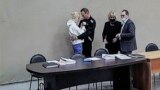 RUSSIA NAVALNY COLONY COURT -- Russian opposition leader and activist Aleksei Navalny and his wife Yulia Navalnaya (L) seen on a monitor screen during an offsite court session in the penal colony N2 (IK-2) in Pokrov, Vladimir region, Russia, 15 February 