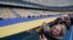 UKRAINE UNITY DAY -- Ukrainians carry a giant National flag on the Olimpiyskiy stadium in Kyiv, Ukraine, 16 February 2022. A giant, 200 meters long National Flag was spread out during the Unity Day celebration amid escalation on the Ukraine-Russian border