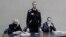 RUSSIA NAVALNY COLONY COURT -- Russian opposition leader and activist Aleksei Navalny (C) is seen on a monitor screen during an offsite court session in the penal colony N2 (IK-2) in Pokrov, Vladimir region, Russia, 15 February 2022. 