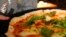 Russia -- A waitress serves pizza at a restaurant in Moscow, September 10, 2014