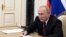 Russian President Vladimir Putin chairs a meeting with members of the country's Paralympic team ahead of the Beijing 2022 Paralympic Winter Games via a video link in Moscow, Russia February 21, 2022. 