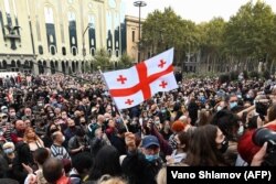 Opposition members protesting the results in Tbilisi gathered outside parliament on November 1, and then marched up the side of a hill to the space-ship-style residence of ruling party founder, Bidzina Ivanishvili.