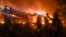 U.S.-- Firefighters battle the Woolsey Fire burning a home in Malibu, Calif., Friday, Nov. 9, 2018
