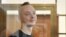 RUSSIA -- Ivan Safronov, a former journalist and an aide to the head of Russia's space agency Roscosmos who remains in custody on state treason charges, stands inside a defendants' cage as he attends a court hearing in Moscow, September 15, 2020