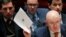 U.S. -- Russian Ambassador to the United Nations (U.N.) Vasily Nebenzya holds a copy of a British report on an incident in Salisbury, UK, during a meeting of the U.N. Security Council at U.N. headquarters in New York, U.S., April 5, 2018