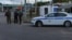 Russian law enforcement officers stand guard at a checkpoint in Belgorod