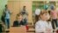 First-grade students and teacher are in school classroom at first lesson