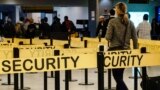 U.S. -- Passengers make their way through a security checkpoint at JFK International Airport in New York in this file photo taken October 11, 2014. 