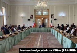 Iranian Foreign Minister Mohammad Javad Zarif (center) talks to delegations of Afghanistan (left) and the Taliban ( right) at the Iranian Foreign Ministry in Tehran, Iran, on July 7, 2021.