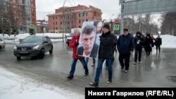 Marchers gather holding a picture of Boris Nemtsov in Novosibirsk on February 29.