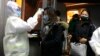 CHINA - Health Officials in hazmat suits check body temperatures of passengers arriving from the city of Wuhan, 22Jan, Wuhan 