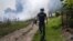 UKRAINE – An AFP journalist runs as smoke rises behind after a bombardment in Bakhmut, Eastern Ukraine, on July 31, 2022