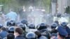 RUSSIA -- Riot police officer confront participants in a rally against the self-isolation order, in front of the Palace of Justice, in North Ossetia's capital Vladikavkaz, April 20, 2020