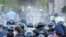 RUSSIA -- Riot police officer confront participants in a rally against the self-isolation order, in front of the Palace of Justice, in North Ossetia's capital Vladikavkaz, April 20, 2020