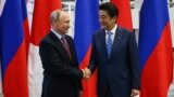 RUSSIA -- Russian President Vladimir Putin (left) meets with Japanese Prime Minister Shunzo Abe in the far-eastern port city of Vladivostok, September 10, 2018