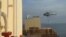 This image grab taken from a UGC video posted on social media on April 13, 2023, shows Iran's Revolutionary Guards rappelling down onto a container ship named, MSC Aries, near the Strait of Hormuz.
