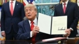 US President Donald Trump holds a letter addressed to Congolese President Felix Tshisekedi congratulating him on the peace agreement with Rwanda during a meeting with Democratic Republic of the Congo Foreign Minister Thérèse Kayikwamba Wagner (R) and Rwan