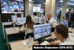 Volunteers at the Moscow Public Election Monitoring Center remotely monitor polling stations during Russia's 2021 parliamentary-regional elections.