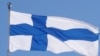 FILE PHOTO: The Finnish flag flutters outside the city hall, as Finland becomes a member of NATO, in Helsinki