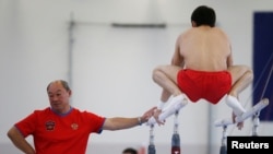 Coach of the gymnastics Russian Olympic team Valery Alfosov and team member Nikolai Kuksenkov