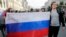 RUSSIA – Protesters hold Russian state flag with sign reading: "Down with the Chekists", during a rally in Moscow, 09Sep2018