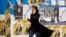 IRAN -- An Iranian woman walks past electoral posters during the last day of election campaign, in Tehran, February 19, 2020