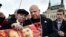 Russia -- US-born mixed martial arts fighter Jeff Monson (C) holds a picture of Lenin and Stalin as he attends a wreath-laying ceremony to mark the 146th birthday of Soviet state founder Vladimir Lenin at his mausoleum in Red Square in Moscow, April 2