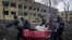 UKRAINE – Ukrainian emergency employees and volunteers carry an injured pregnant woman from the damaged by shelling maternity hospital in Mariupol, March 9, 2022