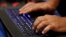 U.S. -- A man types into a keyboard during the Def Con hacker convention in Las Vegas, Nevada, July 29, 2017