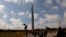 People walk to the Soviet WWII victory monument in Riga