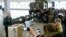 RUSSIA -- Lt. Gen. Mikhail Matveevsky, the chief of the military's missile and artillery forces, left, speaks during a briefing by the Russian Defense Ministry, as the 9M729 land-based cruise missile, center, is displayed near its launcher, right, in Kubi