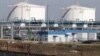 BELARUS -- A car drives past tanks of joint stock company 'Mozyr Oil refinery' at the plant near the city of Mozyr, some 300 km from Minsk, October 24, 2013