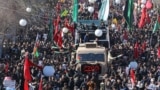 IRAN -- Iranian mourners gather around a vehicle carrying the coffin of slain top general Qasem Soleimani during the final stage of funeral processions, in his hometown Kerman, January 7, 2020