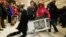 U.K. -- Shoppers wrestle over a television as they compete to purchase retail items on "Black Friday" at an Asda superstore in Wembley, north London November 28, 2014. Britain's high streets, malls and online sites were awash with discounts on Friday as m