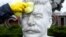 RUSSIA -- A volunteer cleans a bust of Soviet leader Josef Stalin during a community work day in the Muzeon Park of Arts in Moscow, April 13, 2019
