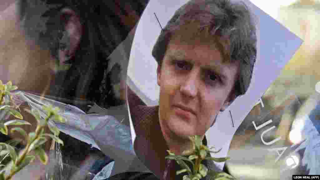 A picture of former Russian security agent Aleksandr Litvinenko is pinned to flowers outside University College Hospital in central London on November 23, 2007.<br />
<br />
Litvinenko, 43, fell ill on November 1, 2006, after he drank tea that was poisoned with polonium-210, a rare, highly radioactive isotope. He died on November 23, 2006, in the hospital.