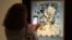A visitor takes a picture with his smatphone at the painting "Gala lacidia,1952" by artist Salvador Dali