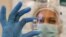 BELARUS PANDEMIC CORONAVIRUS COVID-19 -- A photograph made available on 30 December shows a medical worker showing a vial with Russian Sputnik V vaccine, during the vaccination against the coronavirus disease (COVID-19) at a state polyclinic in Minsk, Bel