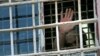 RUSSIA -- ITAR-TASS: VLADIMIR REGION, RUSSIA. JUNE 26, 2013. An inmate waves from a barred window at Prison No.2 in Vladimir Retion, operated by the Administration of the Federal Service of Execution of Punishments (UFSIN). (Photo ITAR-TASS / Stanislav Kr