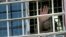 RUSSIA -- ITAR-TASS: VLADIMIR REGION, RUSSIA. JUNE 26, 2013. An inmate waves from a barred window at Prison No.2 in Vladimir Retion, operated by the Administration of the Federal Service of Execution of Punishments (UFSIN). (Photo ITAR-TASS / Stanislav Kr
