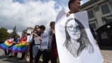 UKRAINE -- Activists of Ukrainian LGBT community hold a LGBT flag, signs reading " Stop Russian world" "stop hate" and pictures of Yelena Grigoryeva in front of the Russian embassy in Kyiv, July 24, 2019