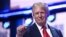 US former President and 2024 Republican presidential candidate Donald Trump holds up a fist onstage during the last day of the 2024 Republican National Convention at the Fiserv Forum in Milwaukee, Wisconsin, on July 18, 2024.