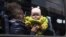 UKRAINE –A woman with a child from Siversk look though the window of a bus during evacuation near Lyman, Donetsk region, May 11, 2022